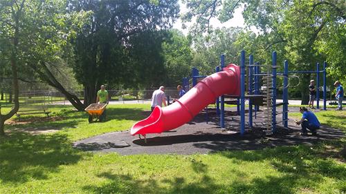 Volunteers picking up a playground area